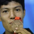 Afghanistan's Rohullah Nikpai attends a press conference with his bronze medal awarded n the men...