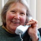 Age Concern Accredited Visitor Service volunteer Mary Bernhardt enjoys a quick chat on the phone...