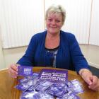 Age Concern Otago social worker Marie Bennett displays  new purple badges to be distributed to...