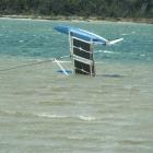 Aileen and Steve Clarke's capsized catamaran in the estuary at Hinahina, near Owaka, yesterday...