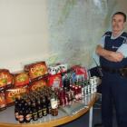 Alcohol harm reduction officer Tom Taylor, of Balclutha, stands next to alcohol confiscated by...
