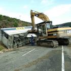 Alex McLellan, of Balclutha, watches yesterday as a tractor excavator is used to pull the crashed...