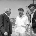 Alexander Downes (left) is congratulated on his 80th birthday by Otago and New Zealand cricketers...