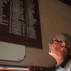 Alexandra bowler Bill Clements looks at his name repeated among a list of title winners at the...