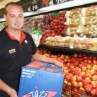 Alexandra New World produce manager Brent Omond with American-grown Jazz apples.  Photo by Lynda...