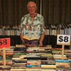 Alexandra Rotary Club book sale co-convener Ken Cook among some of the thousands of books ready...