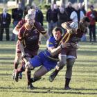 Alhambra-Union first five-eighth Jone Puamau is brought down by Taieri flanker Jeremy Corliss...