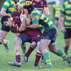 Alhambra-Union No 8 Ben Pereira tries to get away from Green Island No 6 Mika Mafi.