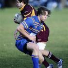 Alhambra-Union winger Chris Gould is tackled by Taieri second five-eighth Shannon Young during a...