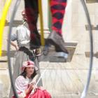 Alicia McAulay of Dunedin, keeps herself cool while watching the penny-farthing championships....