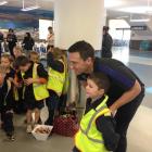 Ben Smith poses for a photograph with Angus McGregor (6), of Elmgrove School, at Dunedin Airport....