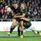 All Black fullback Israel Dagg is wrapped up by Springbok forwards Francois Louw and Flip van der...