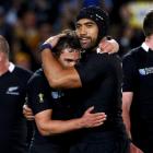 All Black loose forward Victor Vito (centre R) hugs Aaron Cruden after their Rugby World Cup...