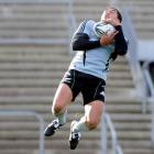 All Black skipper Mils Muliaina goes high to catch the ball at the captain's run at Carisbrook...