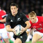 All Blacks first five-eighth Dan Carter is pursued by Wales centre Andrew Bishop during Saturday...