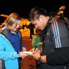 All Blacks hooker Keven Mealamu signs an autograph for Dunedin rugby fan Erin McHenry (12), while...