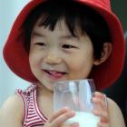 Allie Yin (2), of Dunedin, enjoys a glass of milk yesterday. Photo by Stephen Jaquiery.