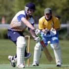 am Wells (Dunedin) chases a delivery as Otago Country wicketkeeper Scott Simpson looks on during...
