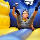 Amelia Eady (10), of Dunedin, takes a tumble on an inflated bungee run at the Edgar Centre. Photo...