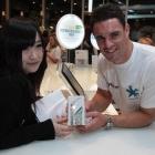 Ami Yang buys her iPhone4 S from All Black Dan Carter at Telecom's Victoria St store in central...