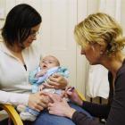 Amity Health Centre practice nurse Pauline Lovelock inoculates Nicholas Hayes (13 weeks), one of...