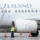 An Air New Zealand Boeing 737's left engine is inspected yesterday after the plane returned to...