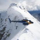 An Alpine Heliski Ltd chopper sits atop Temple Peak, near Glenorchy, in April this year. Photo...