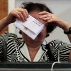 An Egyptian woman casts her vote inside a polling station during presidential elections in Cairo....