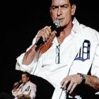 An image of Charlie Sheen is projected in the background as he performs at the Fox Theatre in...