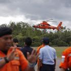 An Indonesian Search and Rescue helicopter carrying the bodies of two AirAsia passengers...