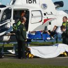 An injured skier is transferred at the Kitchener St helipad in Dunedin on August 4. Photo by...