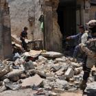 An Iraqi soldier stands guard at the site of a recent bomb attack in a market in the eastern...