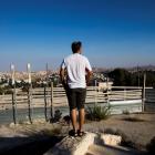 An Israeli man takes part in a ceremony announcing the resumption of construction of an Israeli...