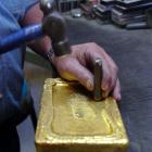 An Oceana Gold employee stamps a raw, unrefined "dore" gold bar weighing 17.42kg before it is...