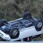 An overturned  car in Fernhill Rd, Queenstown, yesterday, near the Sainsbury Rd turnoff. Photo by...