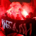 Anarchists burn flares during a protest after voting closed in Russia's parliamentary election in...