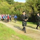 Andrew McColm (left) and Gordon Watson, of the Dunedin City Pipe Band, lead a group of 80 walkers...