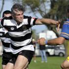 Andrew Stead fends off a tackle. Photo from ODT files.