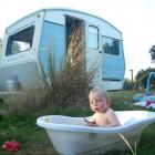 Angus Winneke (1), of Dunedin, takes a bath during a holiday in his family's 1974 Sprite caravan....