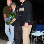 Lance Evans (left) and Lox Kellas (right) help Vietnam veteran Winata (Jimmy) Opai lay a wreath...