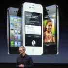 Apple CEO Tim Cook speaks in front of an image of an iPhone 4S at Apple headquarters in Cupertino...