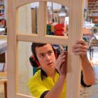 Apprentice joiner James Buchanan sands the door that qualified him for the WorldSkills...