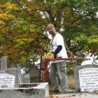 Archaeologist Hans-Dieter Bader uses ground penetrating radar to find unmarked graves in the St...