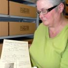 Archives New Zealand archivist Vivienne Cuff with a certificate of registration and photograph of...