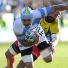 Argentina's Juan Manuel Leguizamon sights the tryline in the tackle of Valentin Ursache, of...