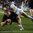 Argentina wing Gonzalo Camacho fails to stop All Black No 8 Kieran Read going over to score a try...