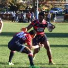 Arrowtown player Joji Ravula (with the ball) goes into battle with Cromwell. Photo by Christina...