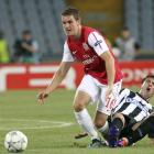 Arsenal's Aaron Ramsey (L) fights for the ball with Giampiero Pinzi of Udinese during their...