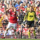 Arsenal's Aaron Ramsey, watched by Manchester United keeper Edwin Van der Sar, reacts after...