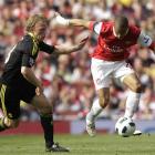Arsenal's Gael Clichy, right, competes with Liverpool's Dirk Kuyt during their English Premier...